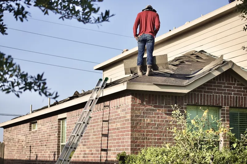Professional roofer working on a residential roof in Pequannock